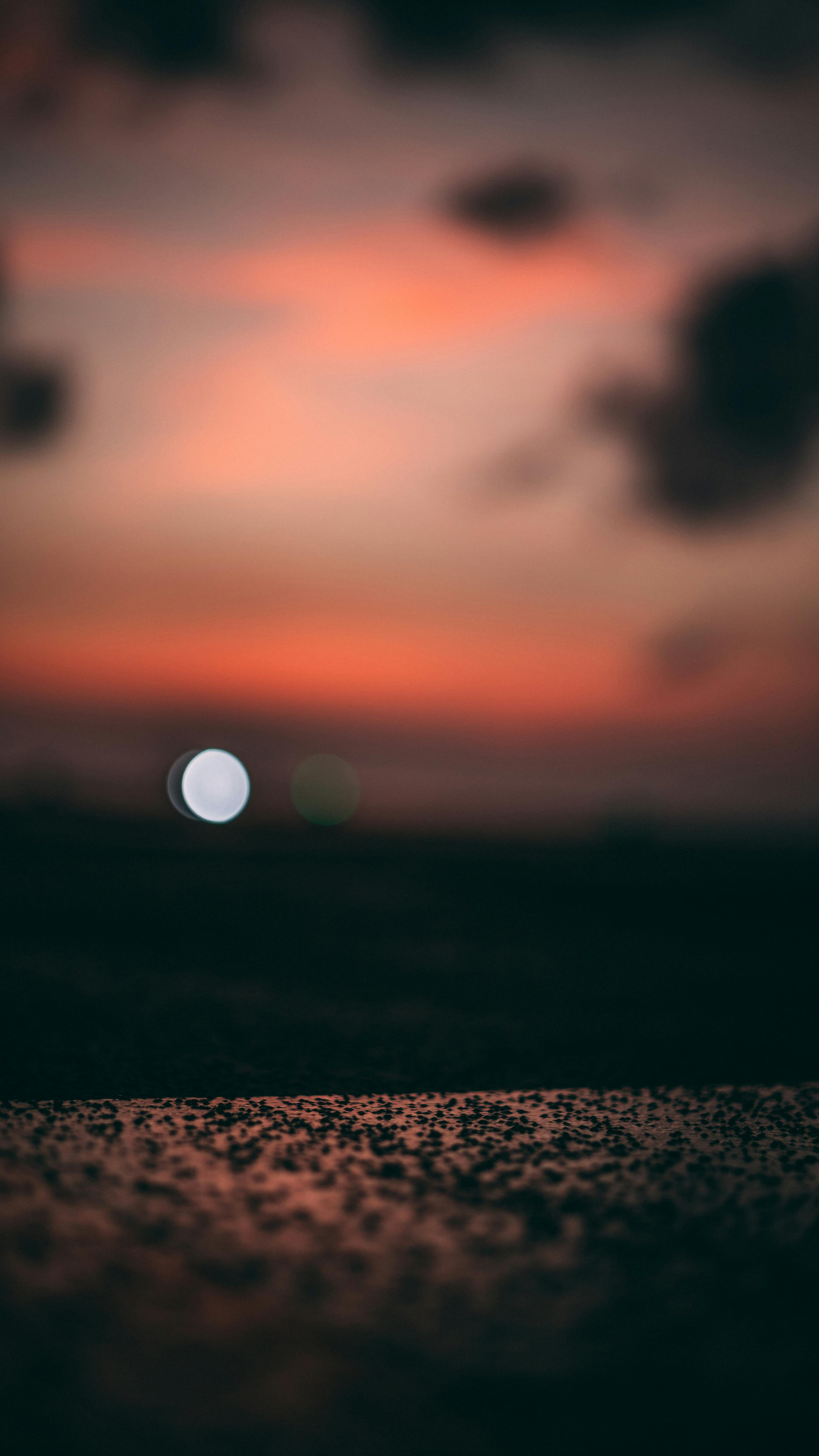 A Tranquil Twilight Scene With A Red Sky And Bokeh Effect, Evoking Calm And Wonder.