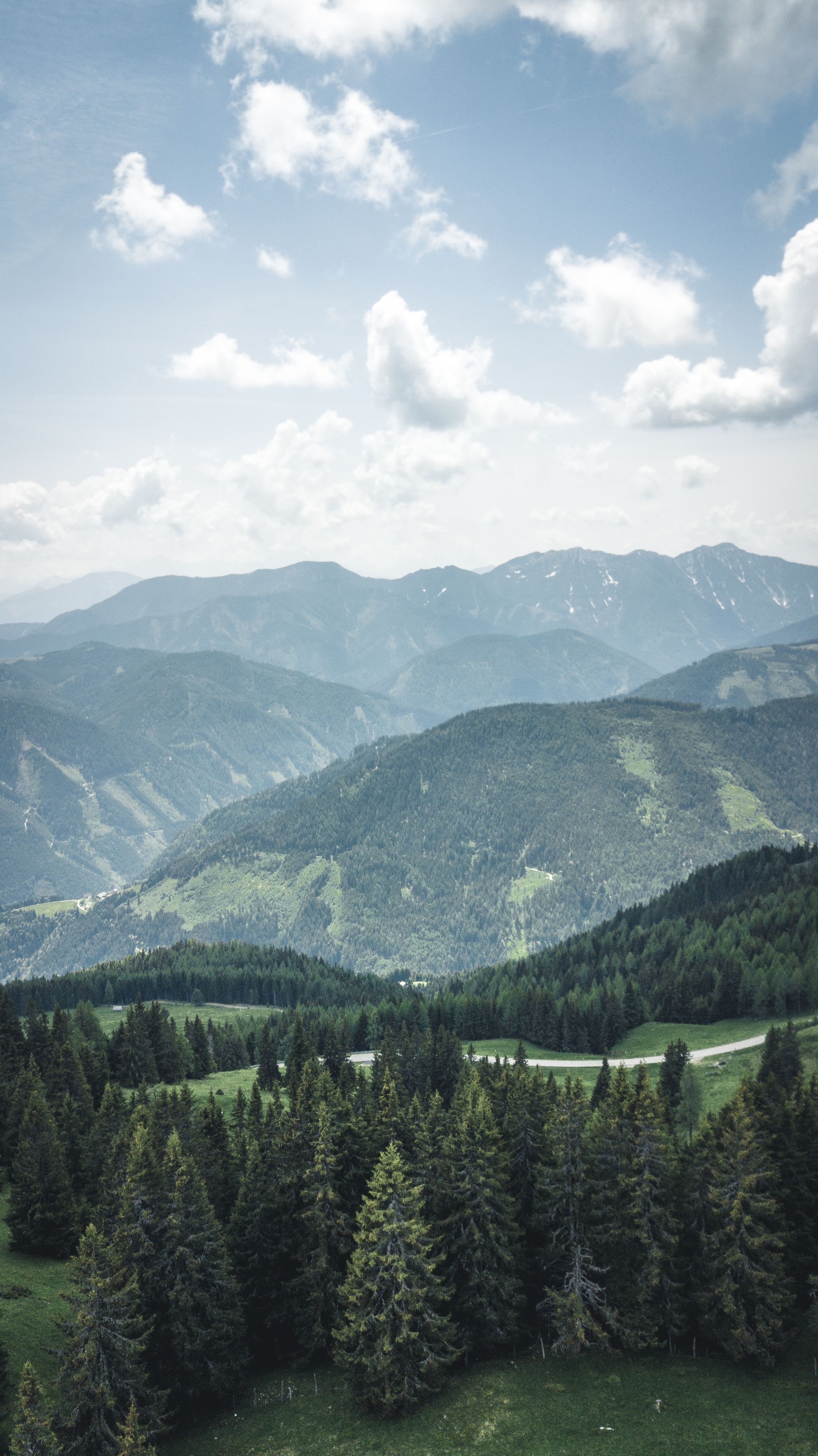 Serene Aerial View Of Lush Green Forests And Mountains In Austria's Countryside.