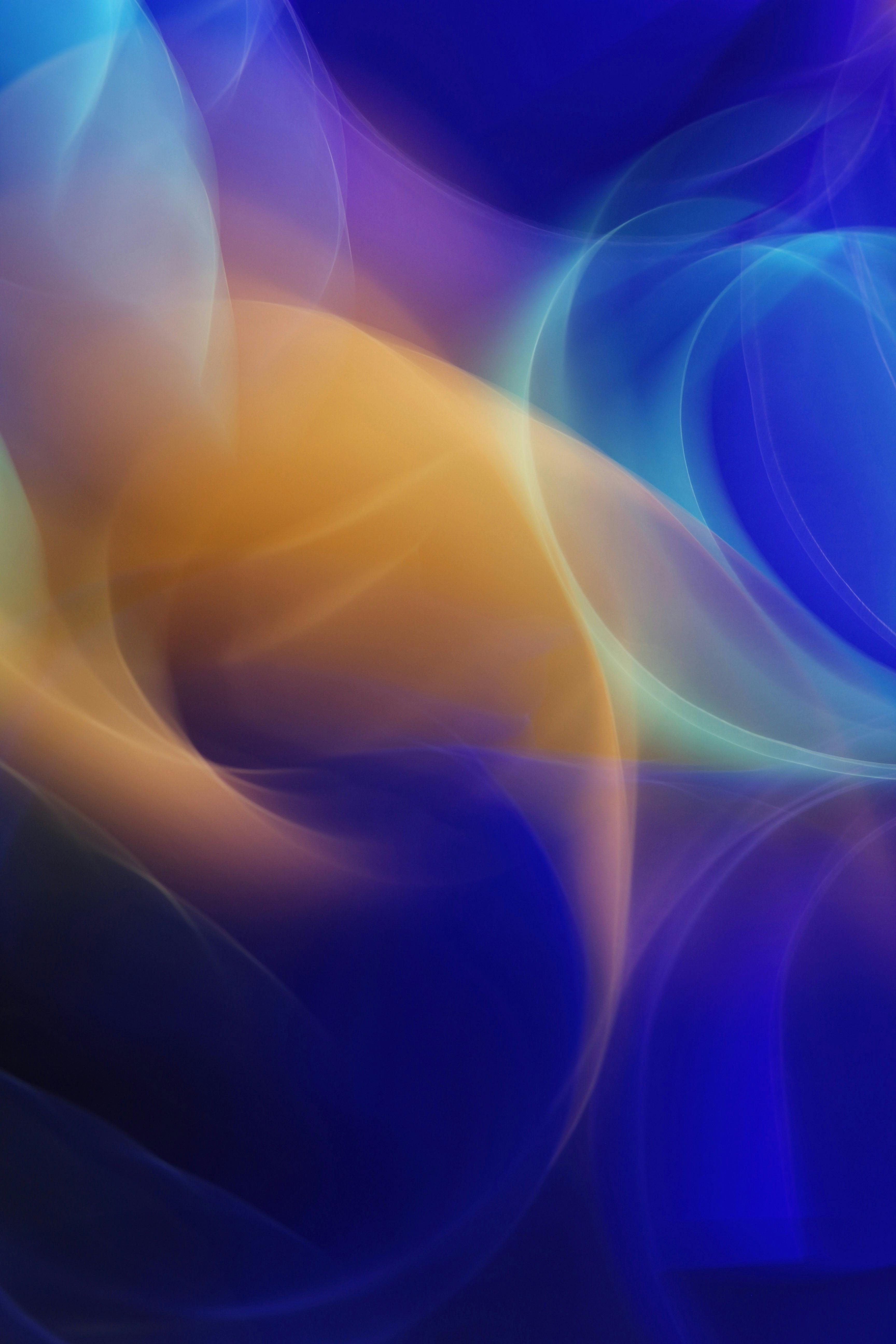 Colorful Abstract Background With Swirling Lights In Blues And Oranges.