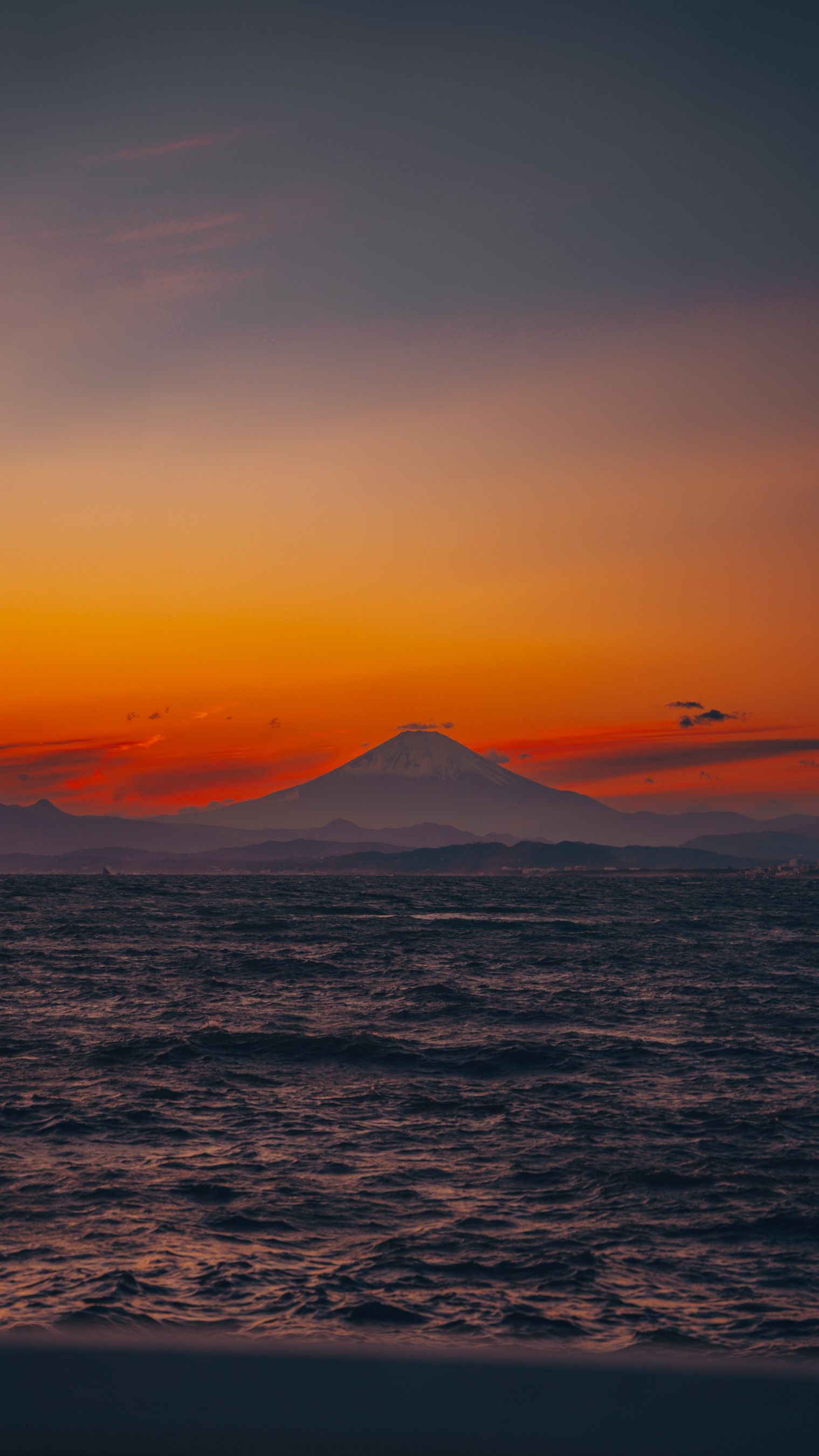 Beautiful Sunset View Of Mount Fuji With A Vibrant Sky Over The Ocean In Kamakura, Japan.