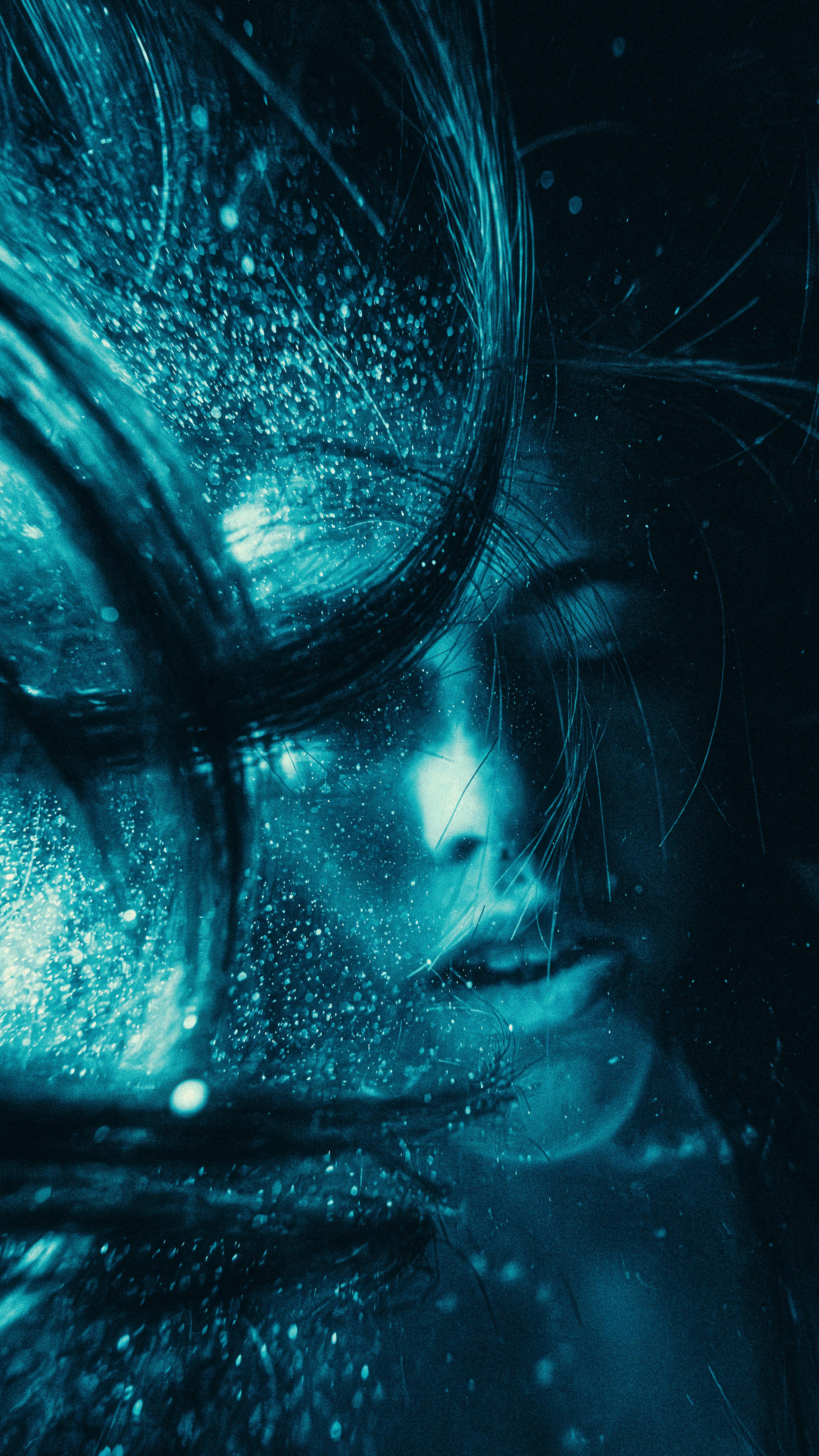 Surreal Underwater Portrait With Blue Hues And Flowing Hair, Creating A Mystical Effect.