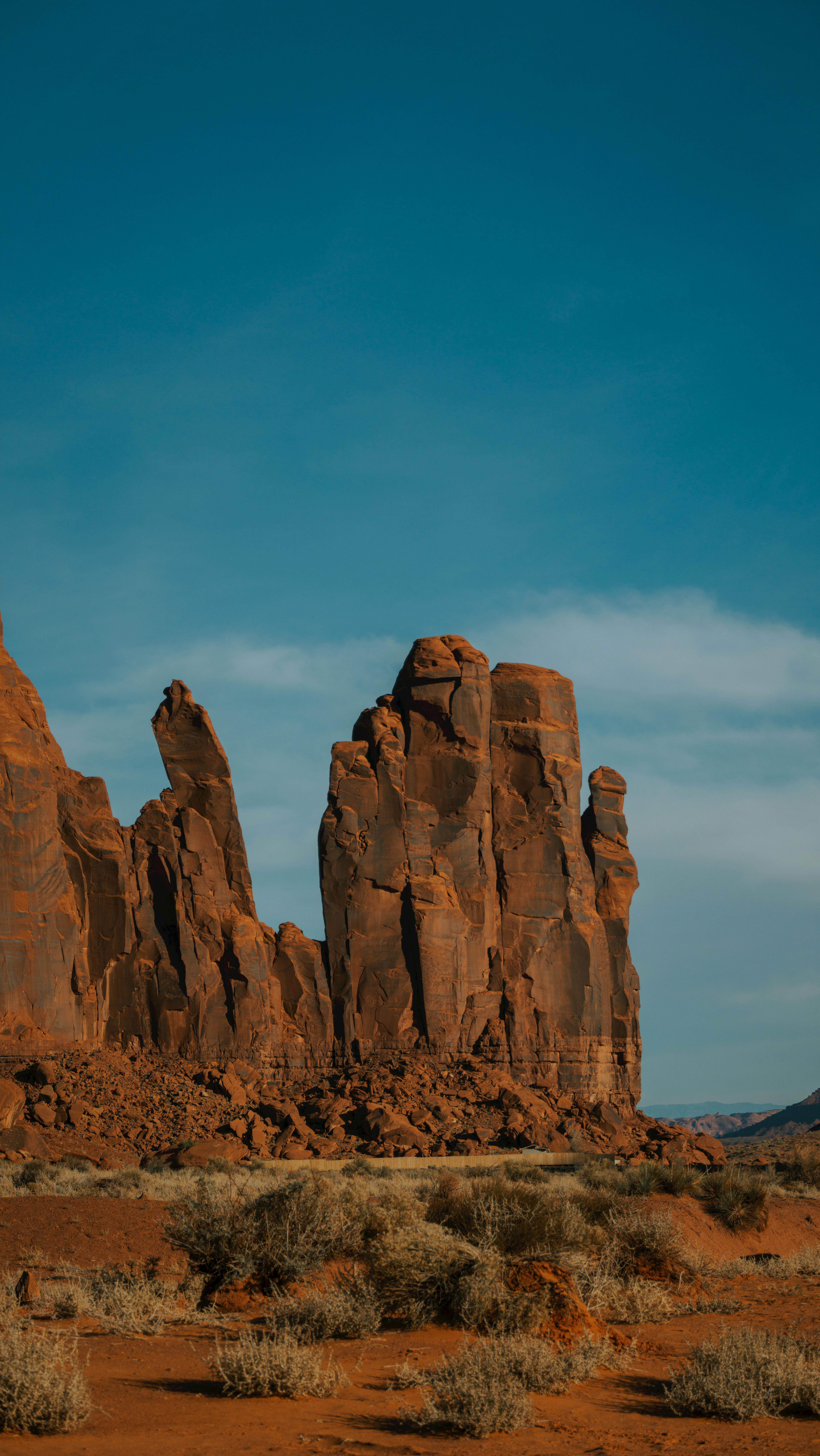 Stunning Red Rock Formations Under A Clear Sky In Arizona, Capturing The Rugged Beauty Of Nature.