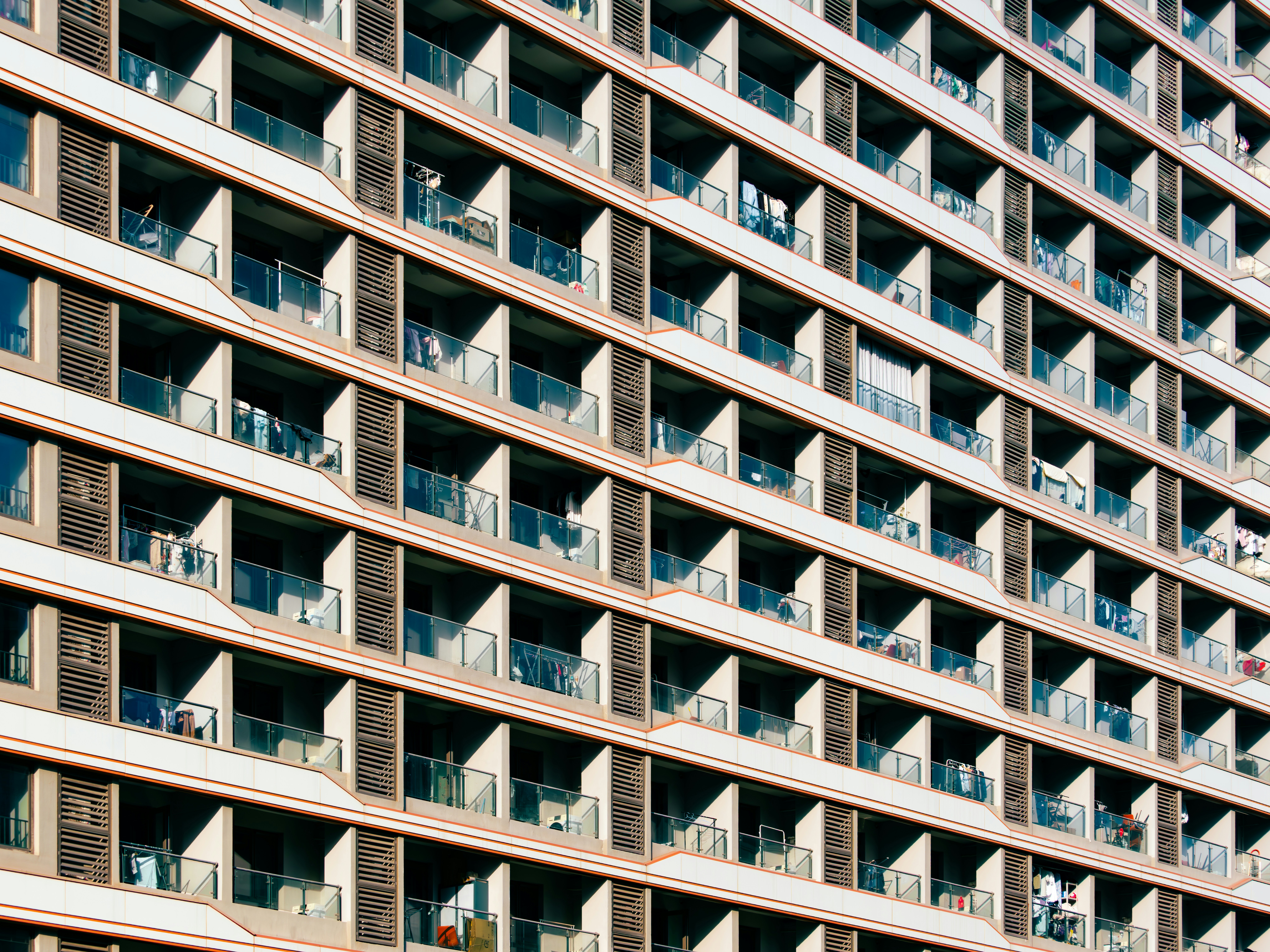Modern Building Facade With Numerous Windows And Balconies.