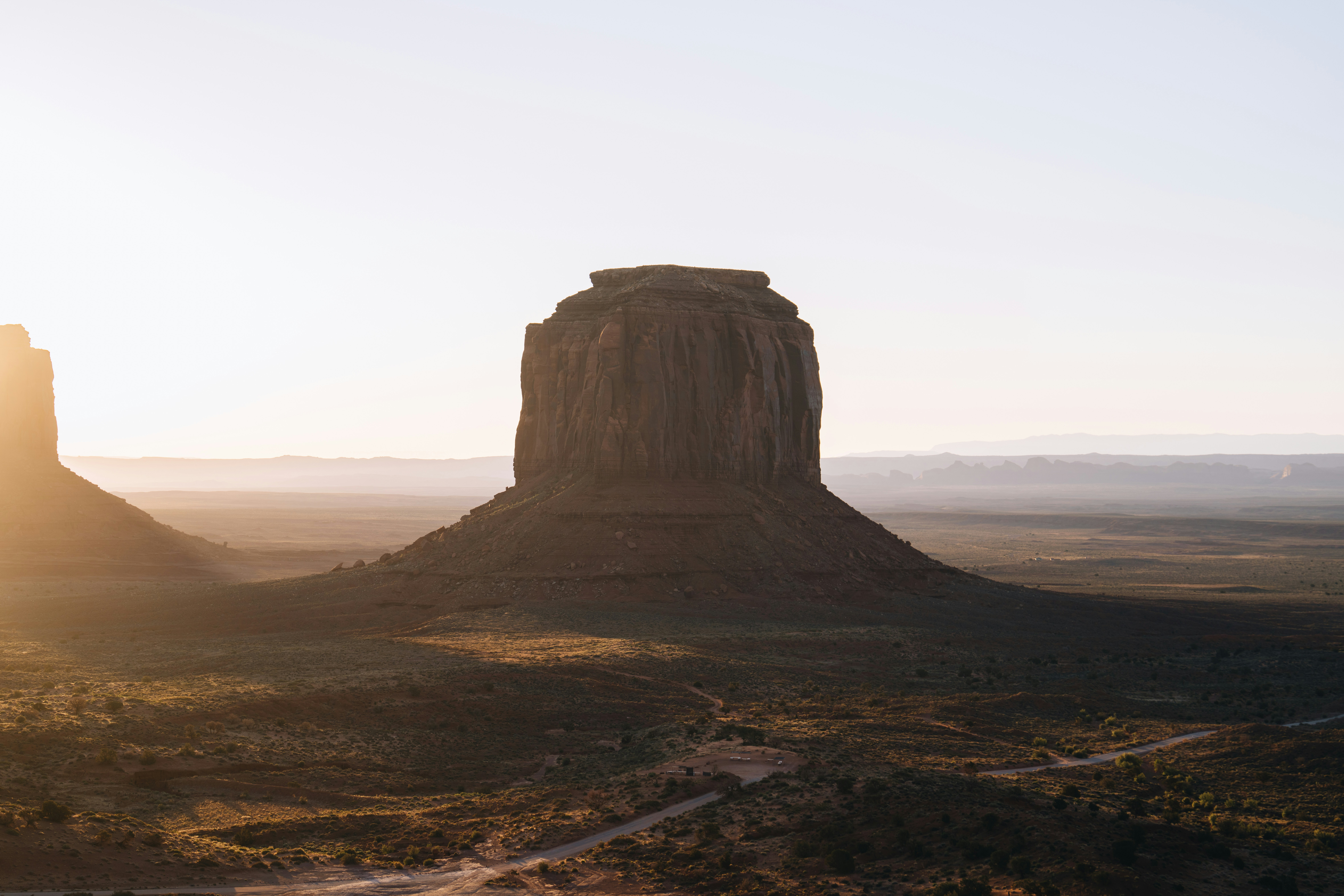 Monument Valley At Sunrise With Warm Light.