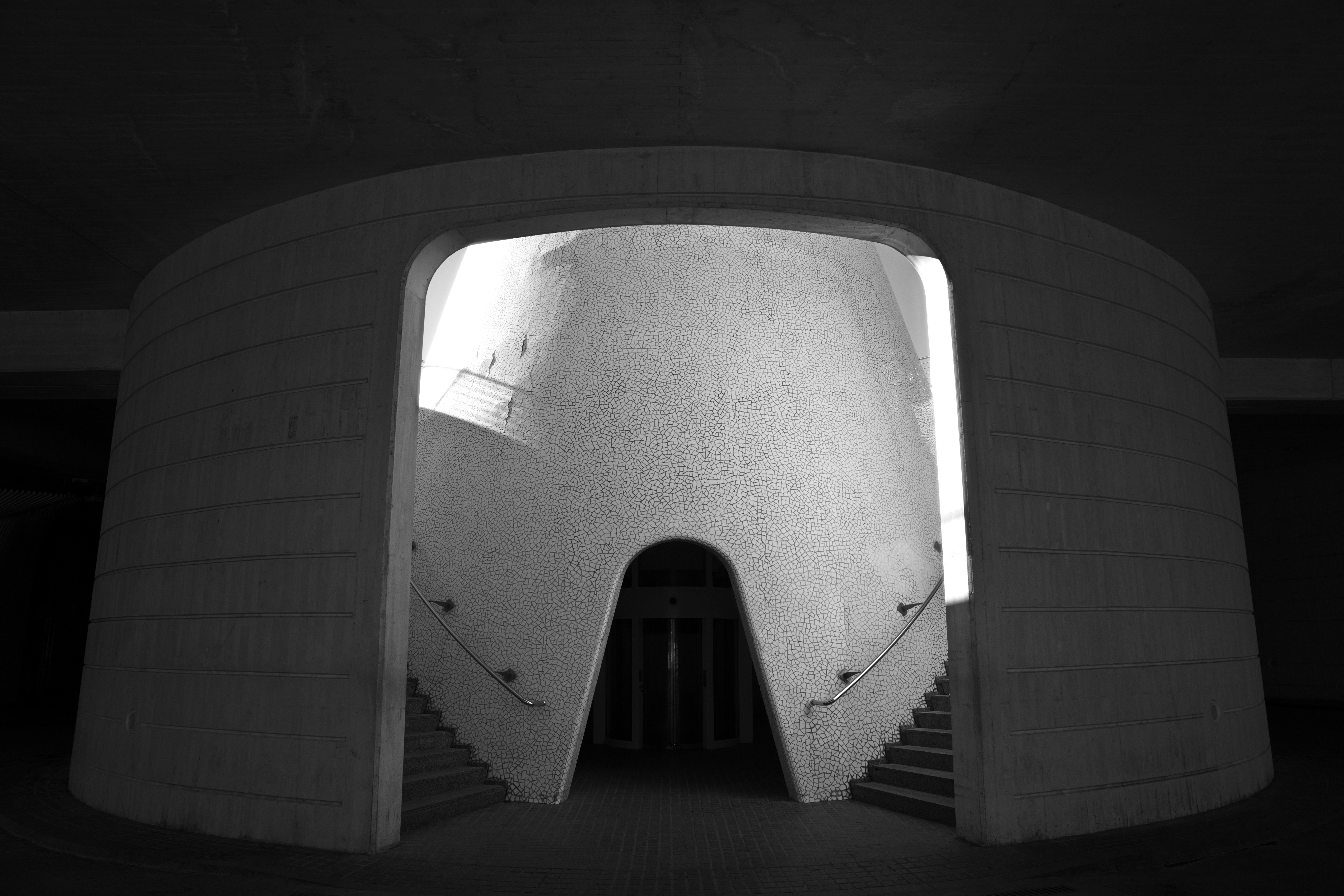Modern Concrete Entryway With Stairs Leading Up