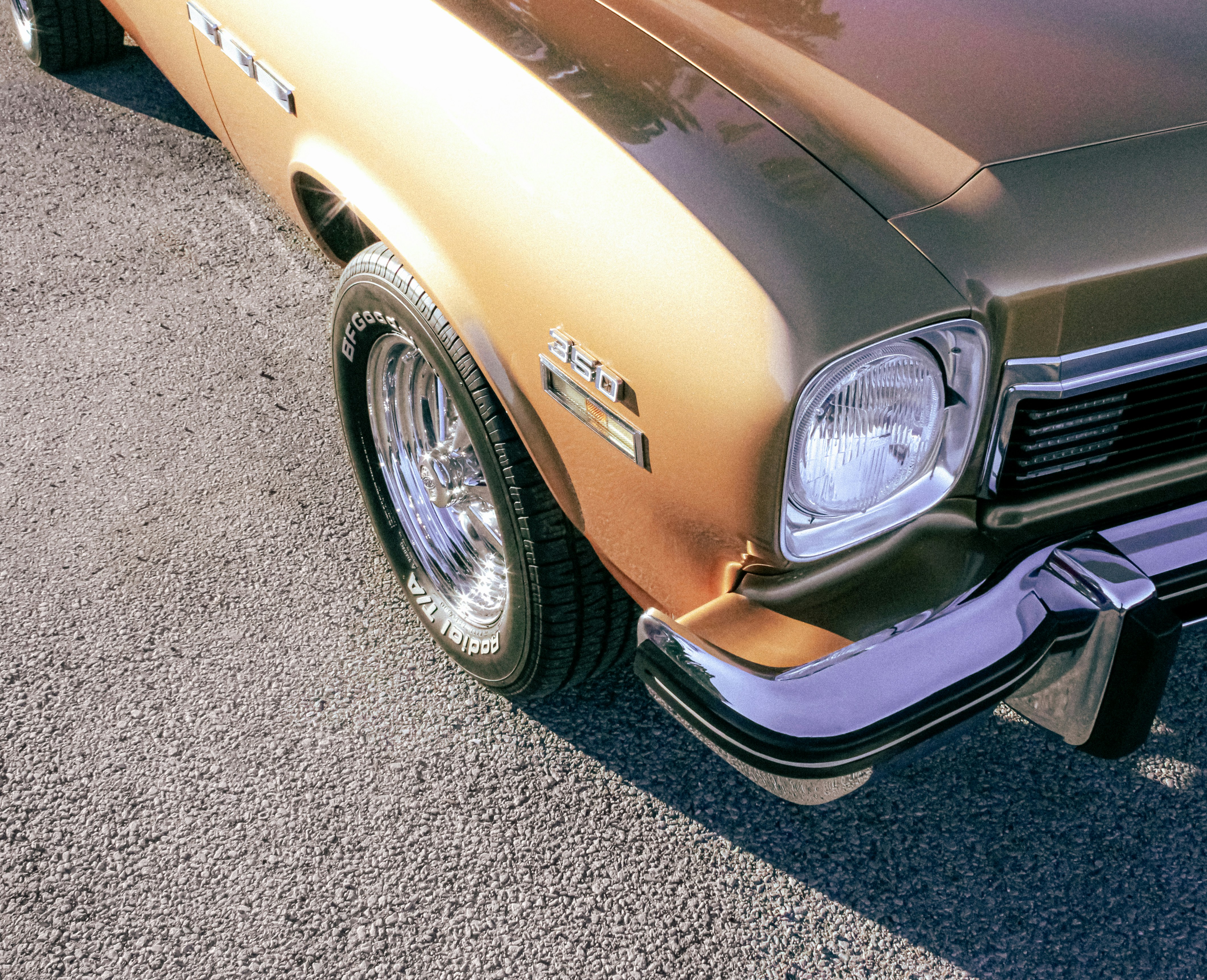 Headlight Of Golden Vintage Classic Car Parked In Sunlight
