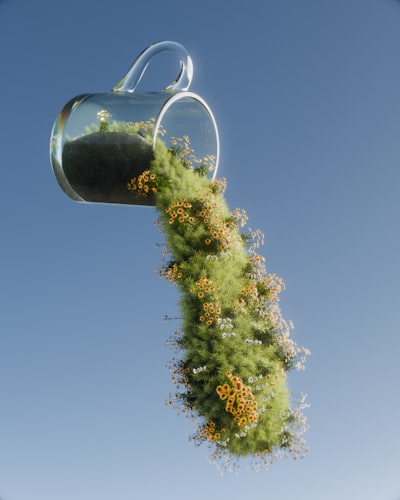 Floating Glass Cup Spills Vibrant Green Grass And Wildflowers. wallpaper preview