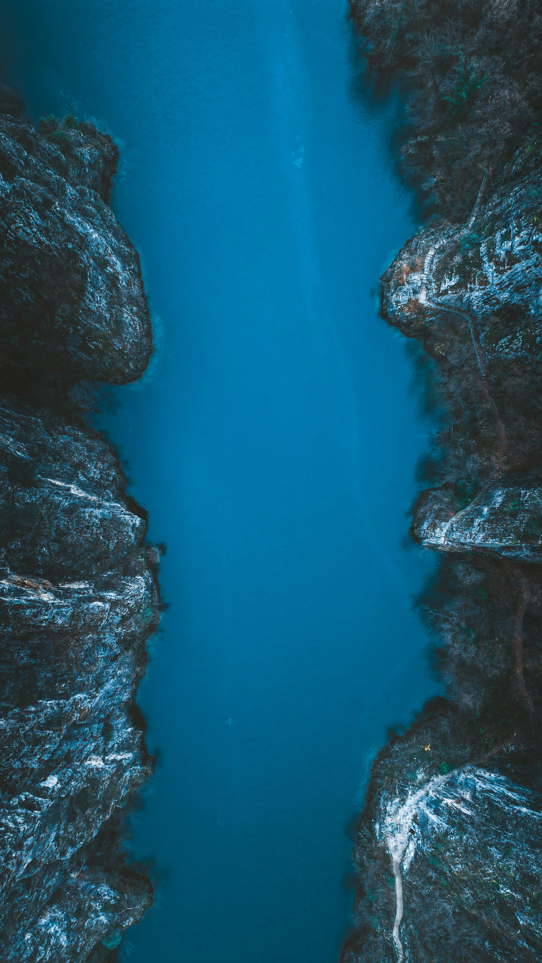 Stunning Aerial View Of A Calm River Gorge Surrounded By Rugged Cliffs. HD mobile wallpaper