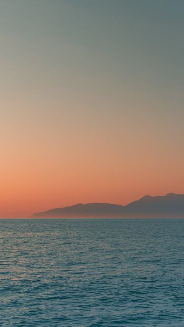 Tranquil Sunset View Over The Serene Sea In Corfu, Greece, With Distant Mountains. wallpaper preview