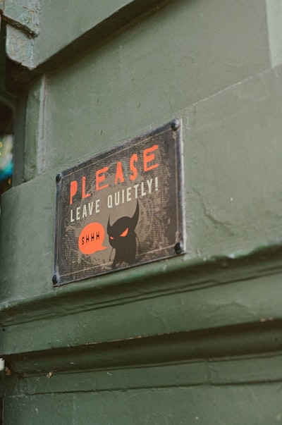 Green Door With A "please Leave Quietly!" Sign And Devil. wallpaper preview