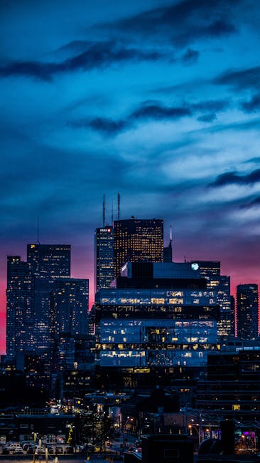 A Vibrant City Skyline With A Dramatic Twilight Sky And Illuminated Buildings. wallpaper preview