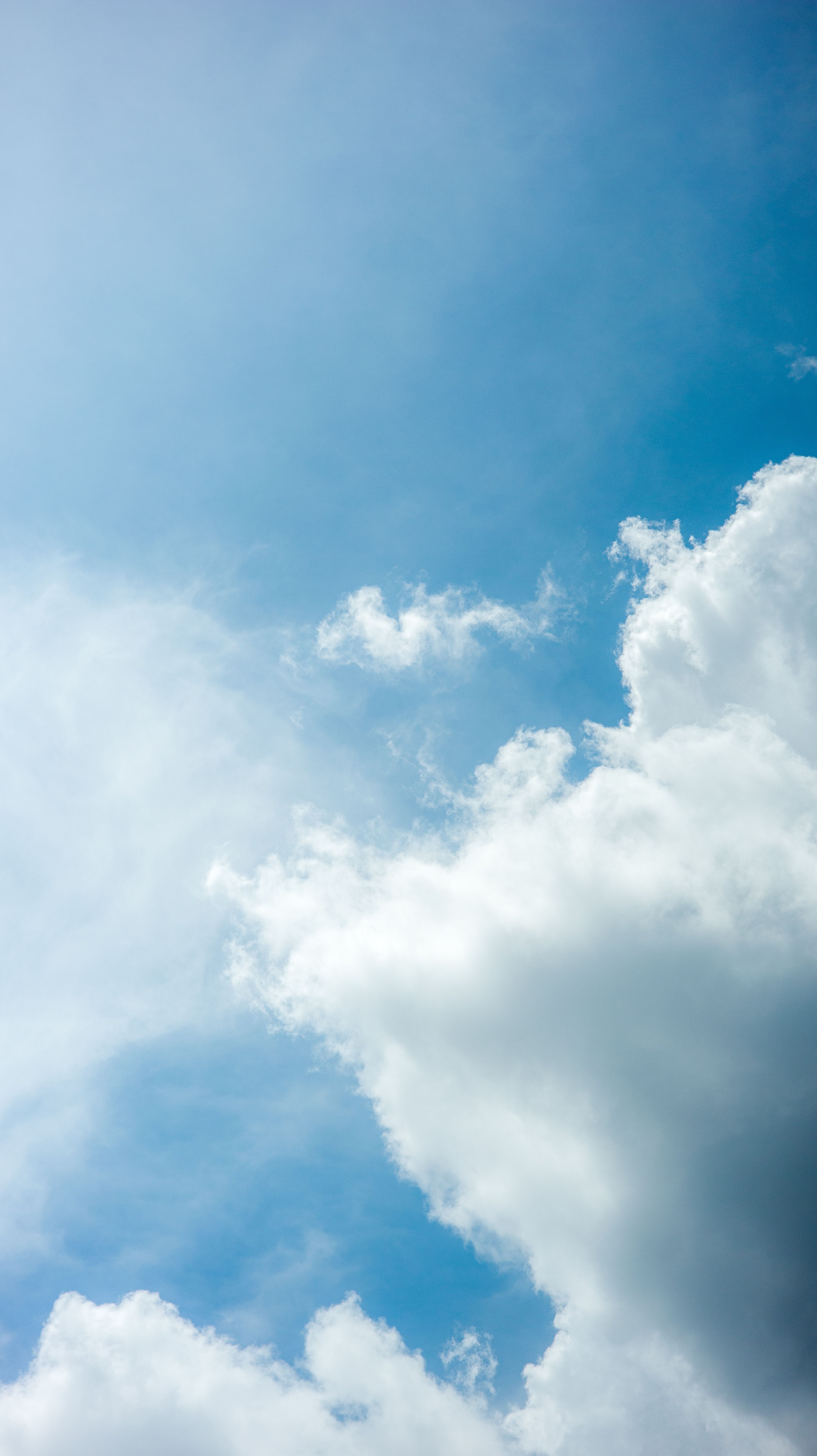 Bright Blue Sky With Fluffy White Clouds, Perfect For Backgrounds Or Nature Themes. HD mobile wallpaper