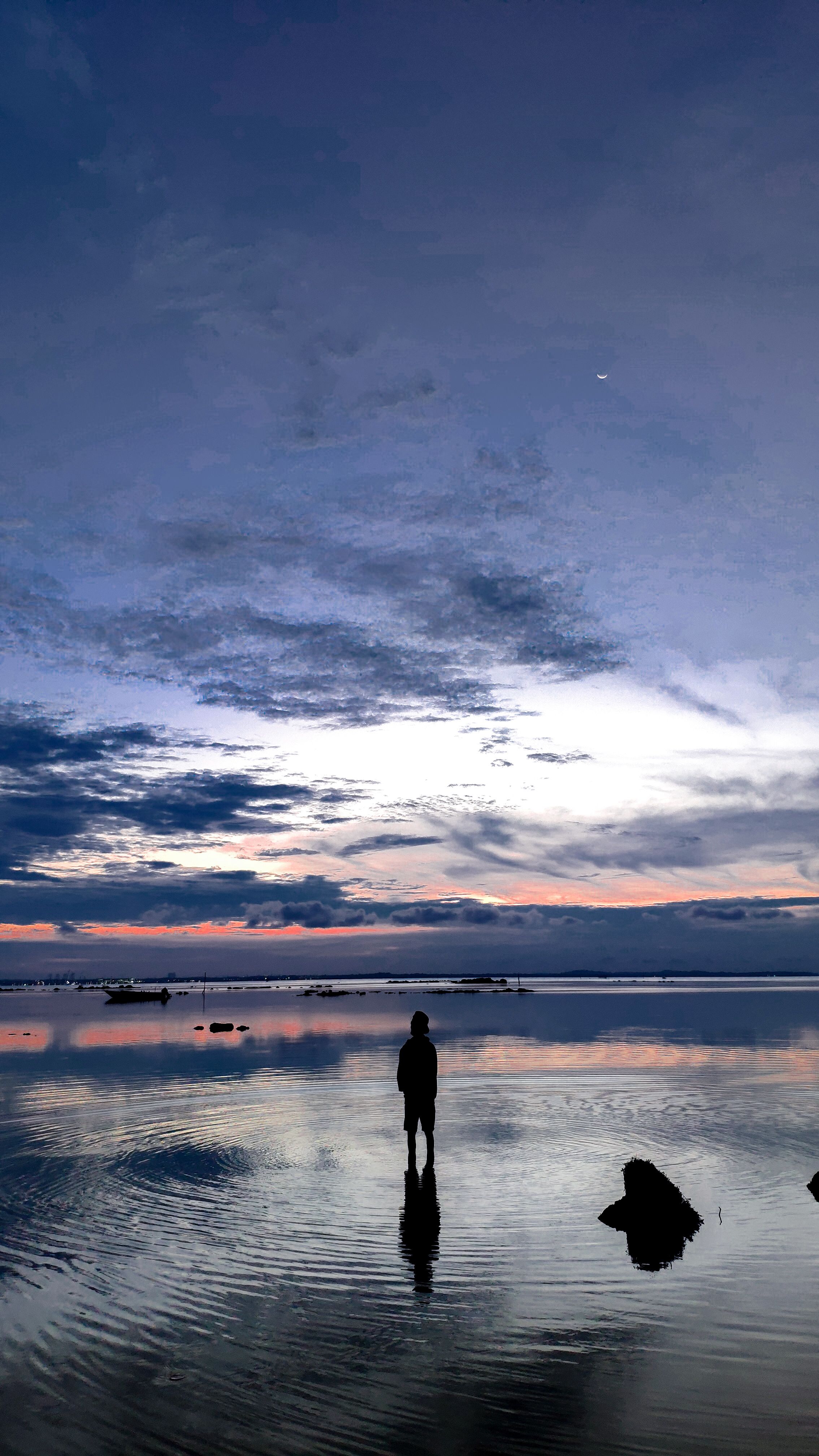 A Serene Silhouette Of A Man Stands By The Ocean At Twilight, Under A Dramatic Cloudy Sky. HD mobile wallpaper