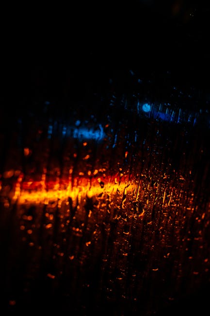 Vibrant Abstract Of Raindrops On Glass With Blue And Orange Lights. wallpaper preview
