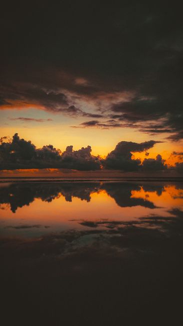 A Breathtaking View Of The Sky And Clouds Reflecting On The Ocean's Surface During The Golden Hour. wallpaper preview