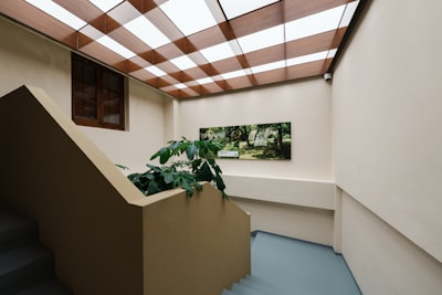 Modern Staircase With Checkered Ceiling And Wall Art wallpaper preview