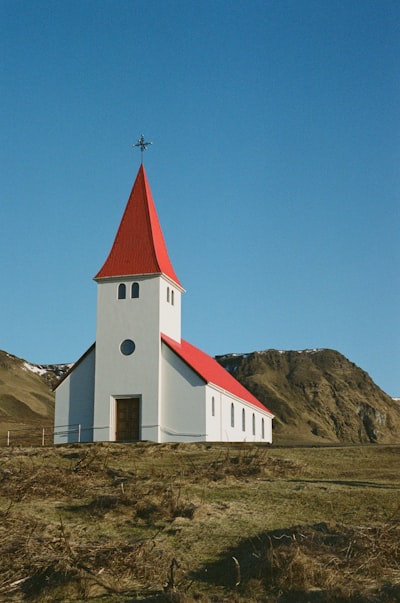 White Church With Red Roof In A Rural Landscape.