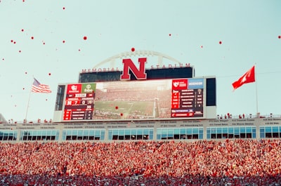 Fans Celebrate At A Football Stadium With Scoreboards. wallpaper preview