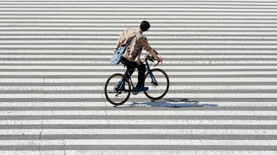 Person Riding A Bicycle On A Crosswalk