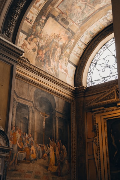Ornate Interior With Religious Frescoes, Paintings, And Arched Window.