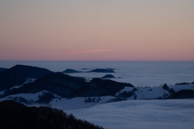 Hills Emerging From A Sea Of Clouds At Dusk wallpaper preview