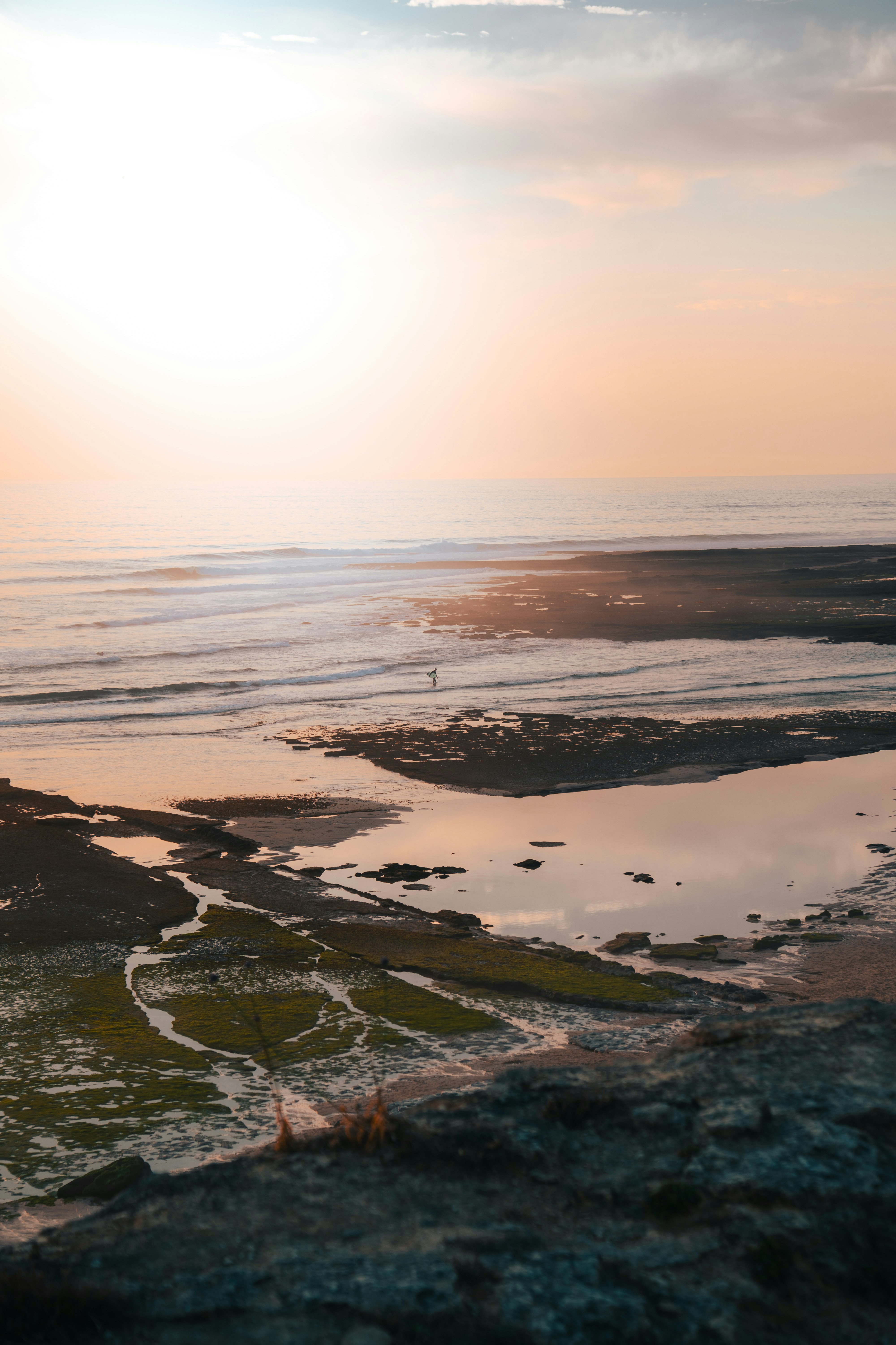 Golden Sunset Illuminates A Rocky Beach With Exposed Tide Pools. HD mobile wallpaper