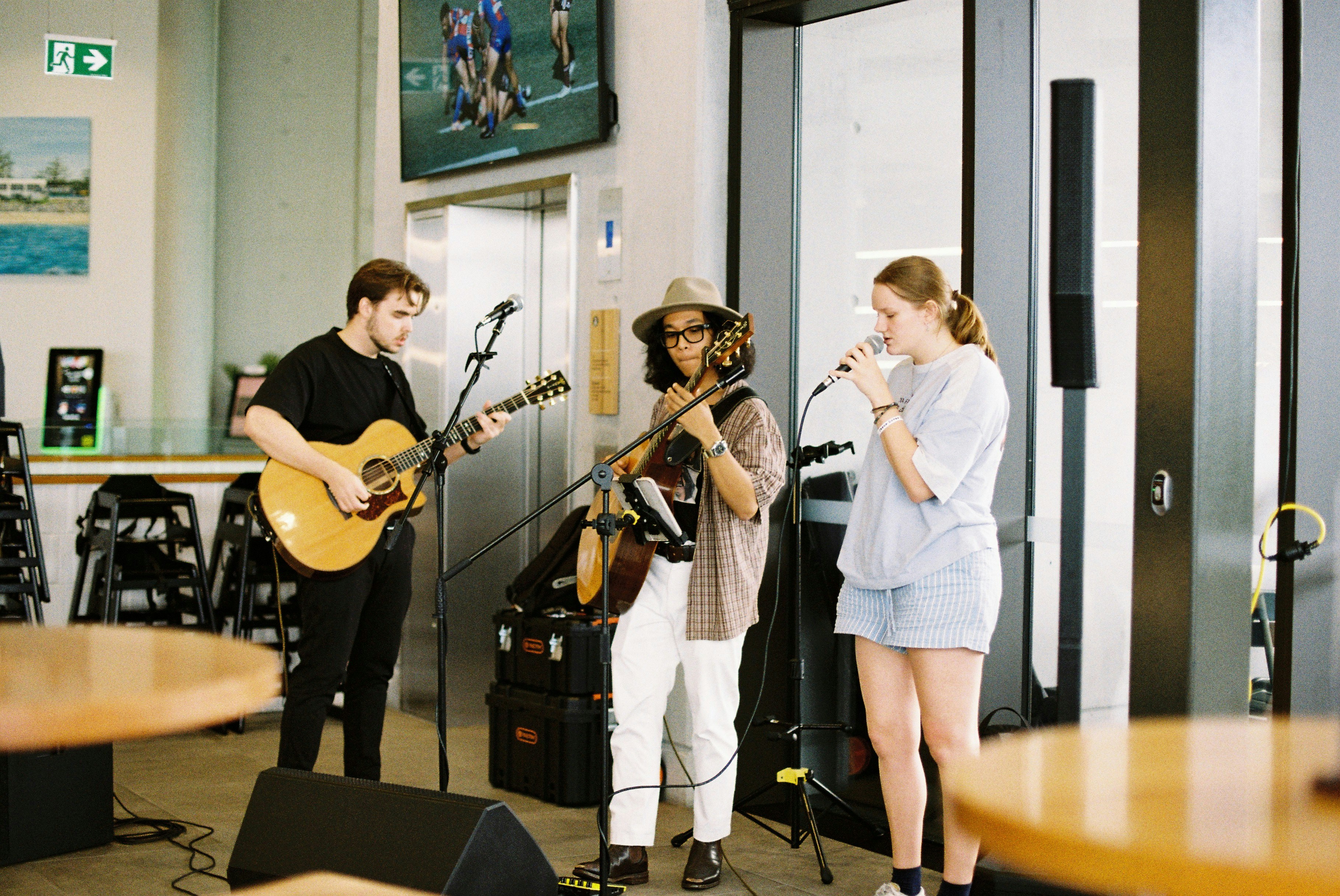Three Musicians Perform Live Music Indoors. HD mobile wallpaper