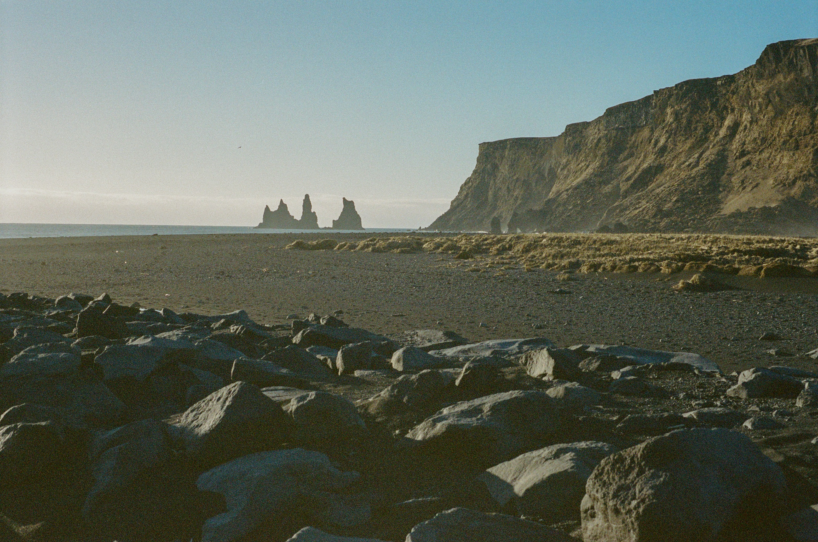 A Rocky Beach With Sea Stacks And A Towering Cliff. HD mobile wallpaper