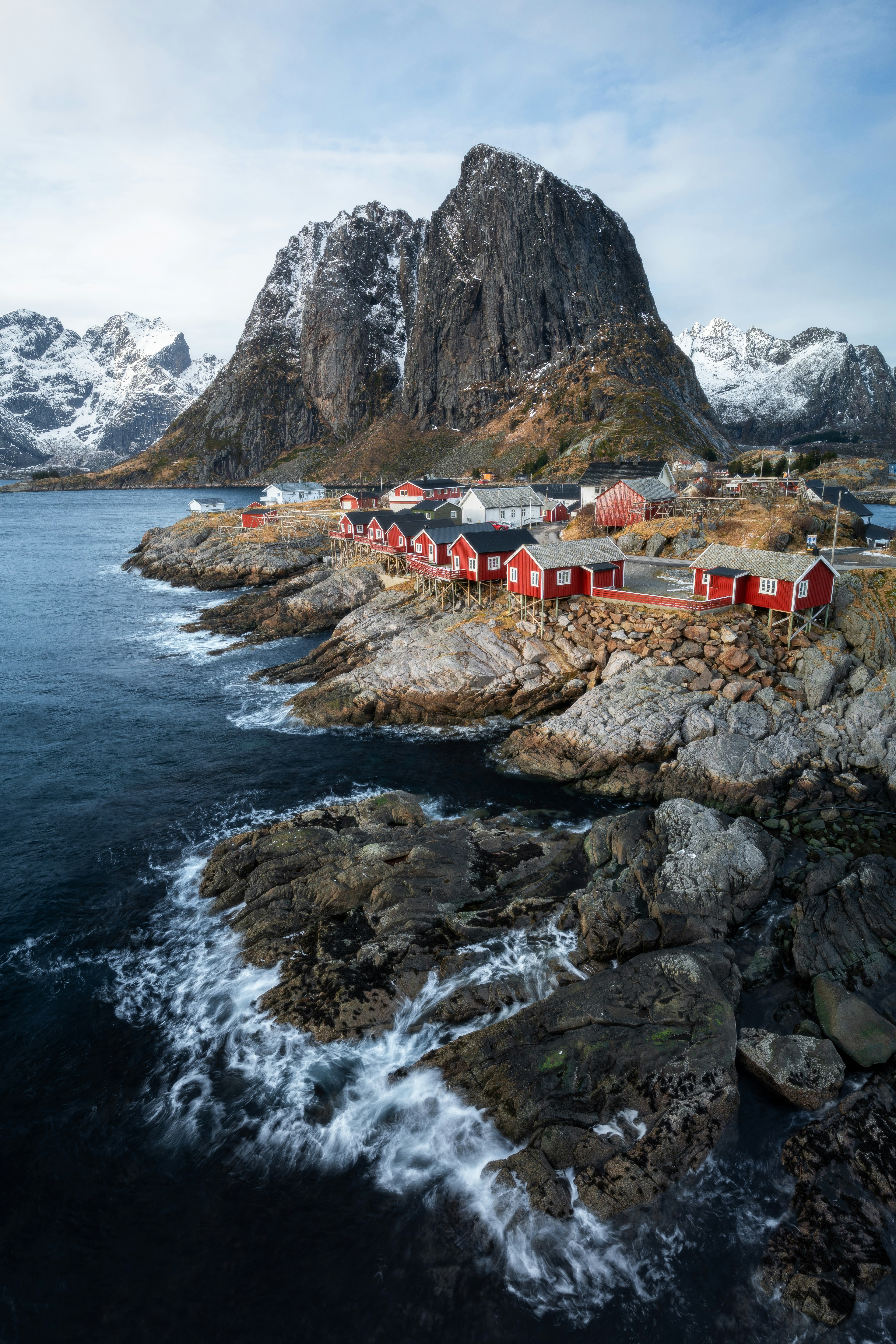 Red Houses Line A Rocky Coast With Snow-capped Mountains. HD mobile wallpaper