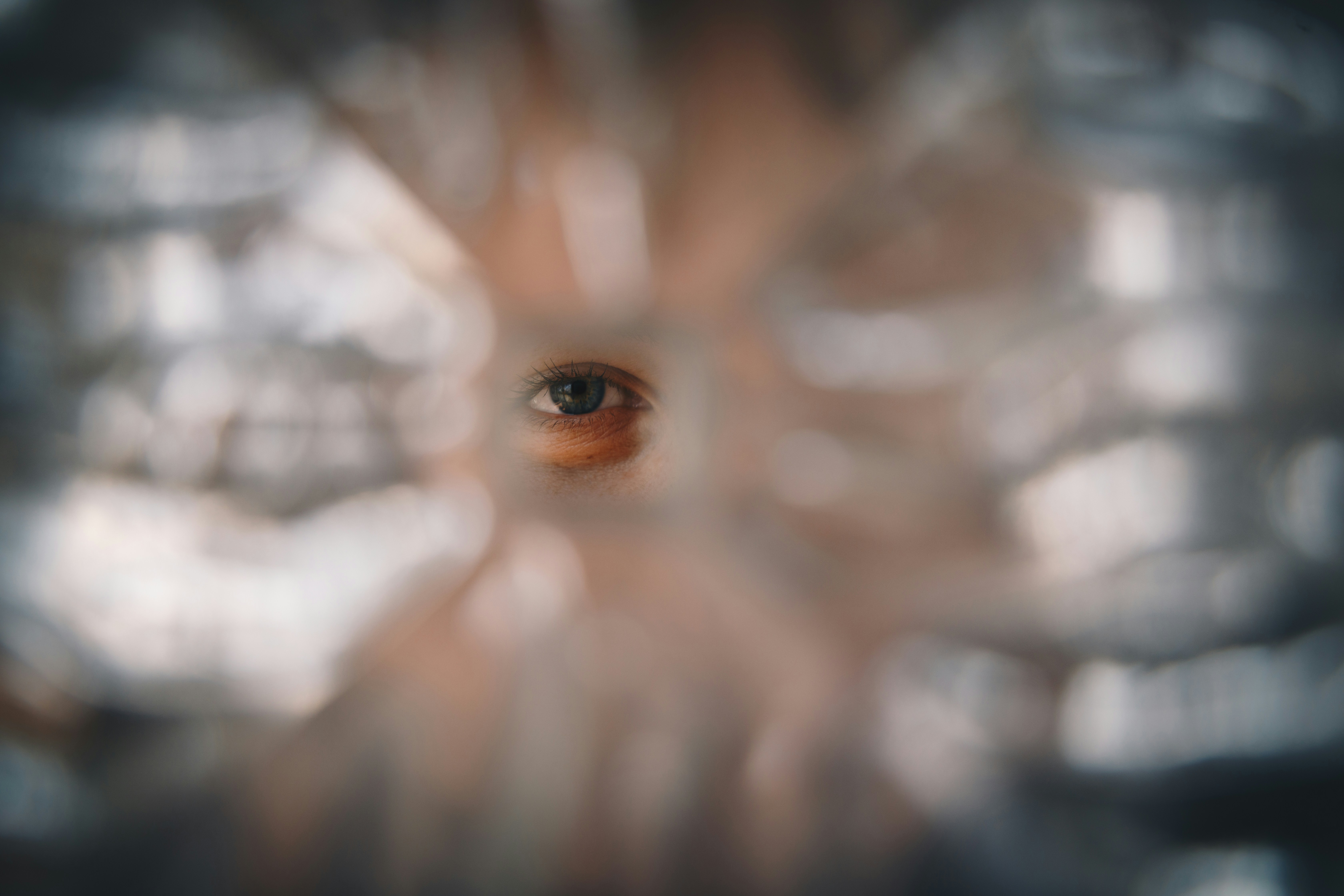 A Blue Eyed Woman Looking Through A Hole In The Glass HD mobile wallpaper