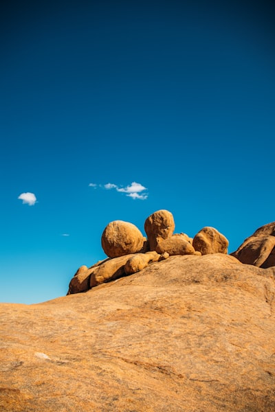 Massive Rock Formations Under A Clear Blue Sky.