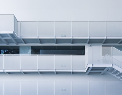 Modern White Building With Balconies And Stairs