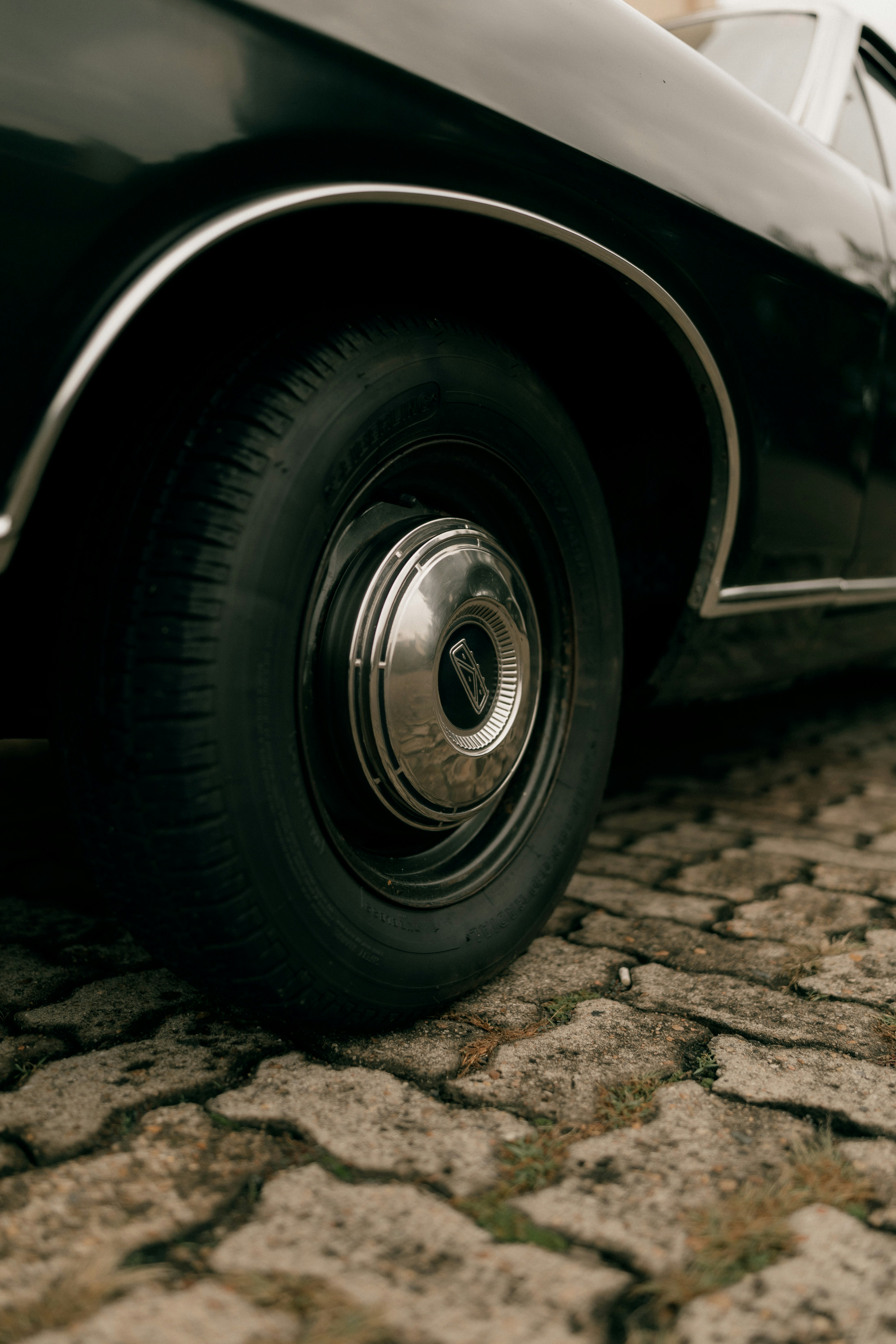 Close Up Of A Vintage Car Wheel On Cobblestone HD mobile wallpaper