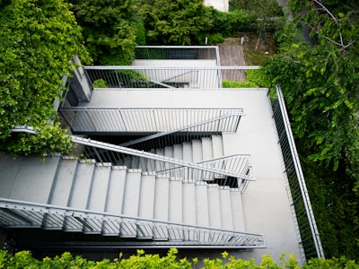 Modern Outdoor Staircase Winding Down Through Green Foliage. wallpaper preview