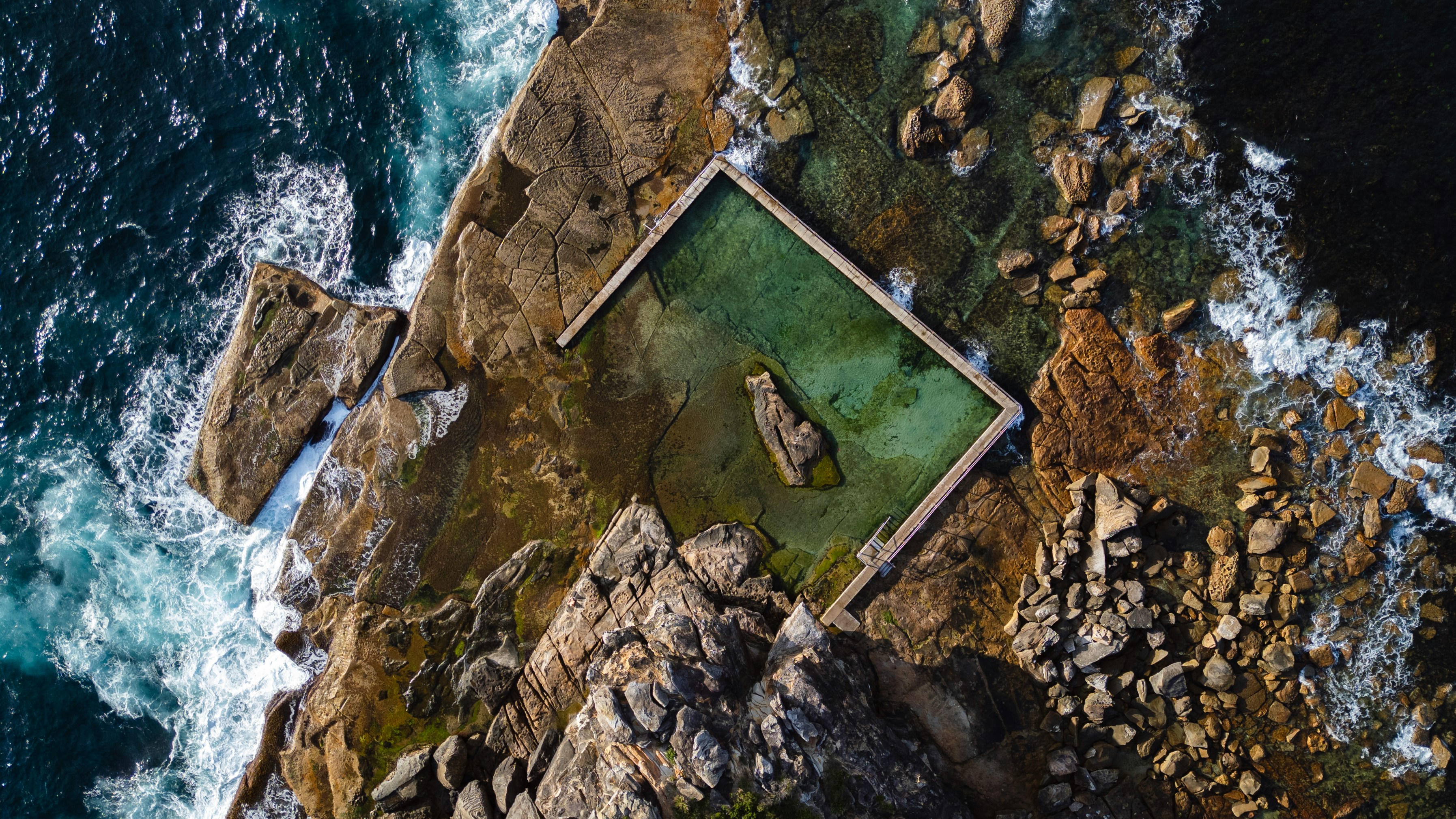 Aerial View Of A Rock Pool On A Rugged Coastline. HD mobile wallpaper