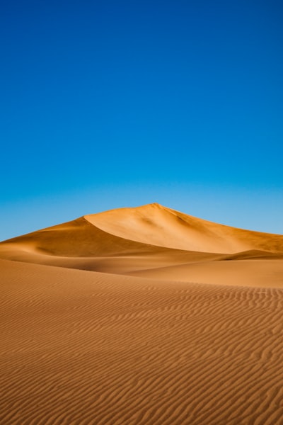 Golden Sand Dunes Under A Clear Blue Desert Sky. wallpaper preview