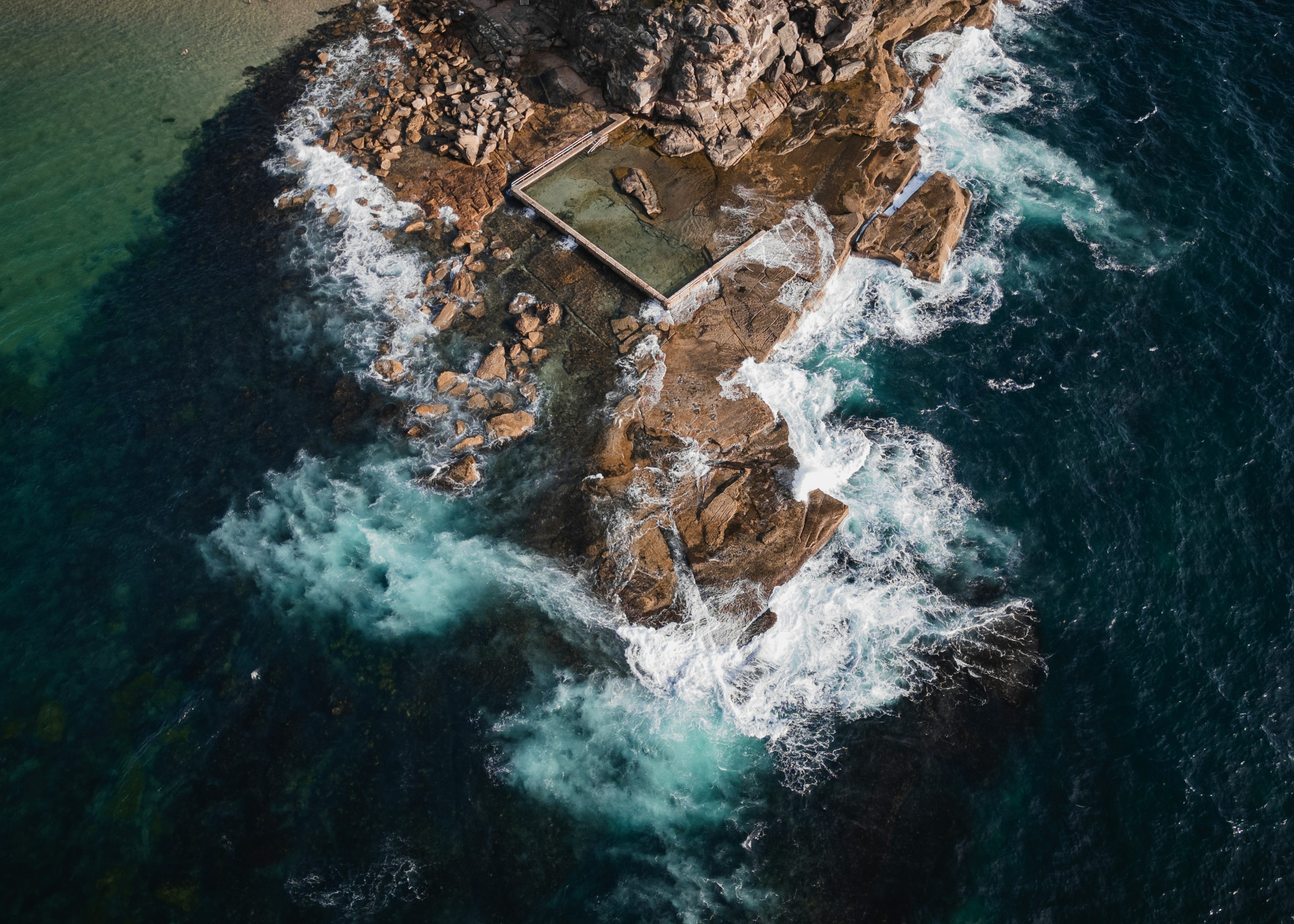 Aerial View Of An Ocean Pool Surrounded By Crashing Waves. HD mobile wallpaper