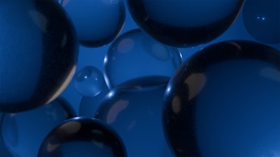 Numerous Blue Translucent Spheres Floating Against A Blue Background.