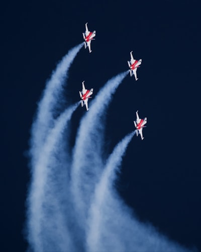 Five Fighter Jets Flying With Smoke Trails In Dark Sky.