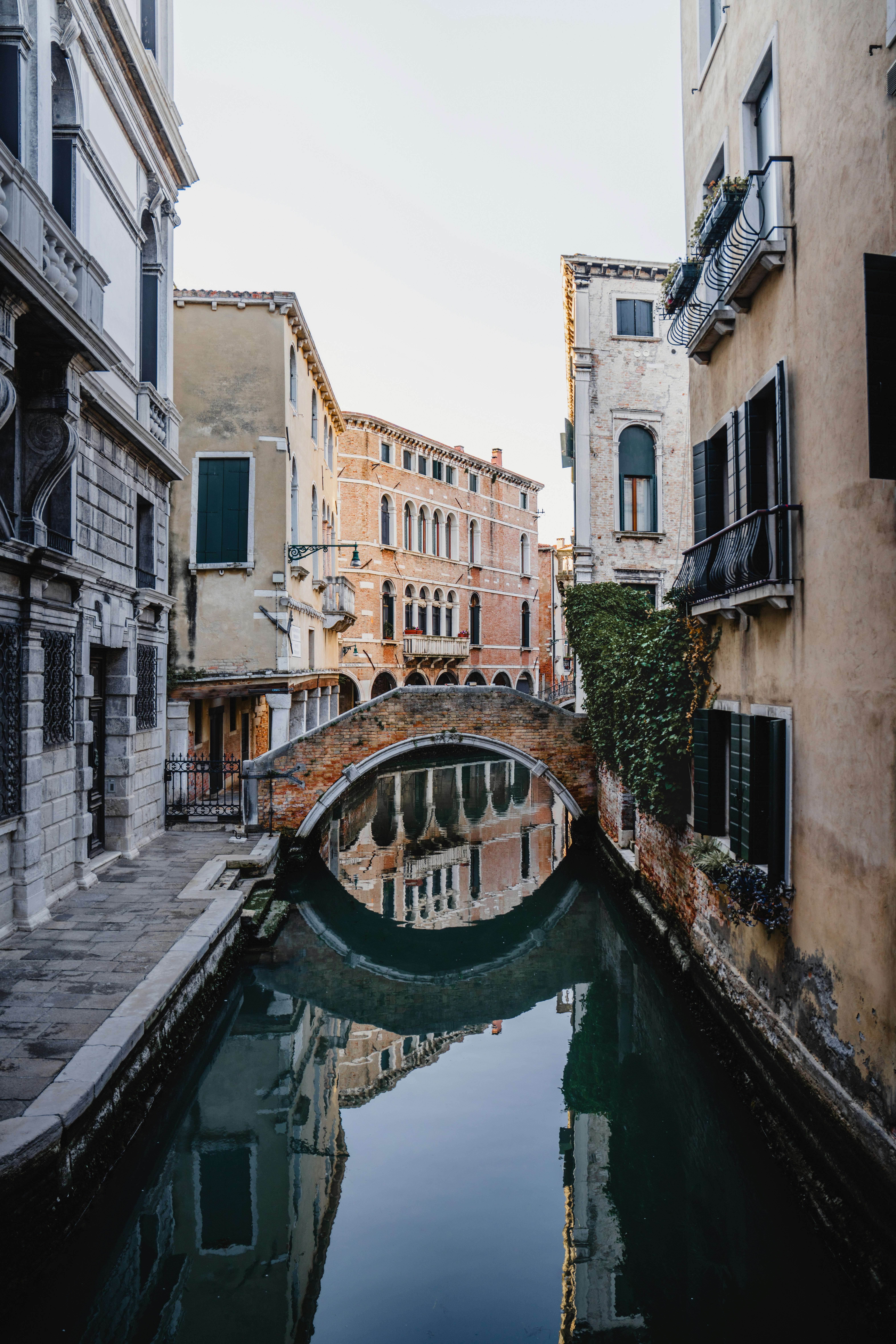 Historic Venetian Canal With Arched Bridge And Building Reflections. HD mobile wallpaper