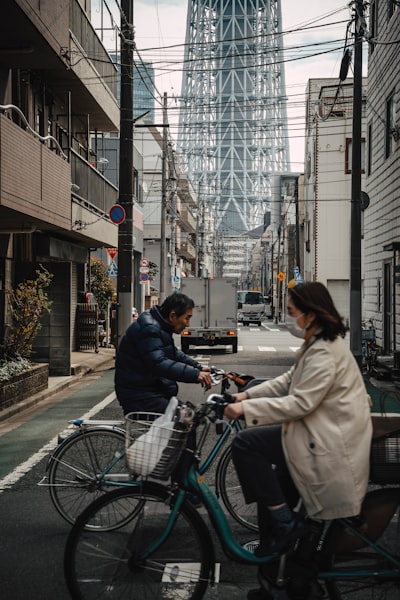 Cyclists On Tokyo Street Beneath Skytree wallpaper preview