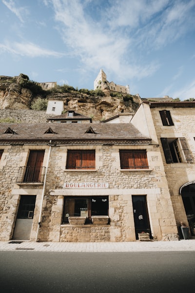 Historic Stone Boulangerie Building Beneath A Village On A Cliff. wallpaper preview