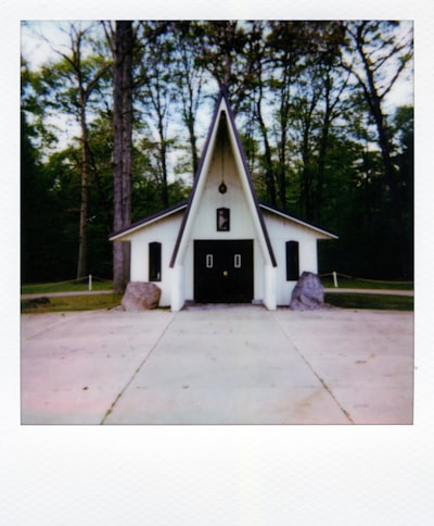 Small White Chapel With A Pointed Roof In Forest wallpaper preview