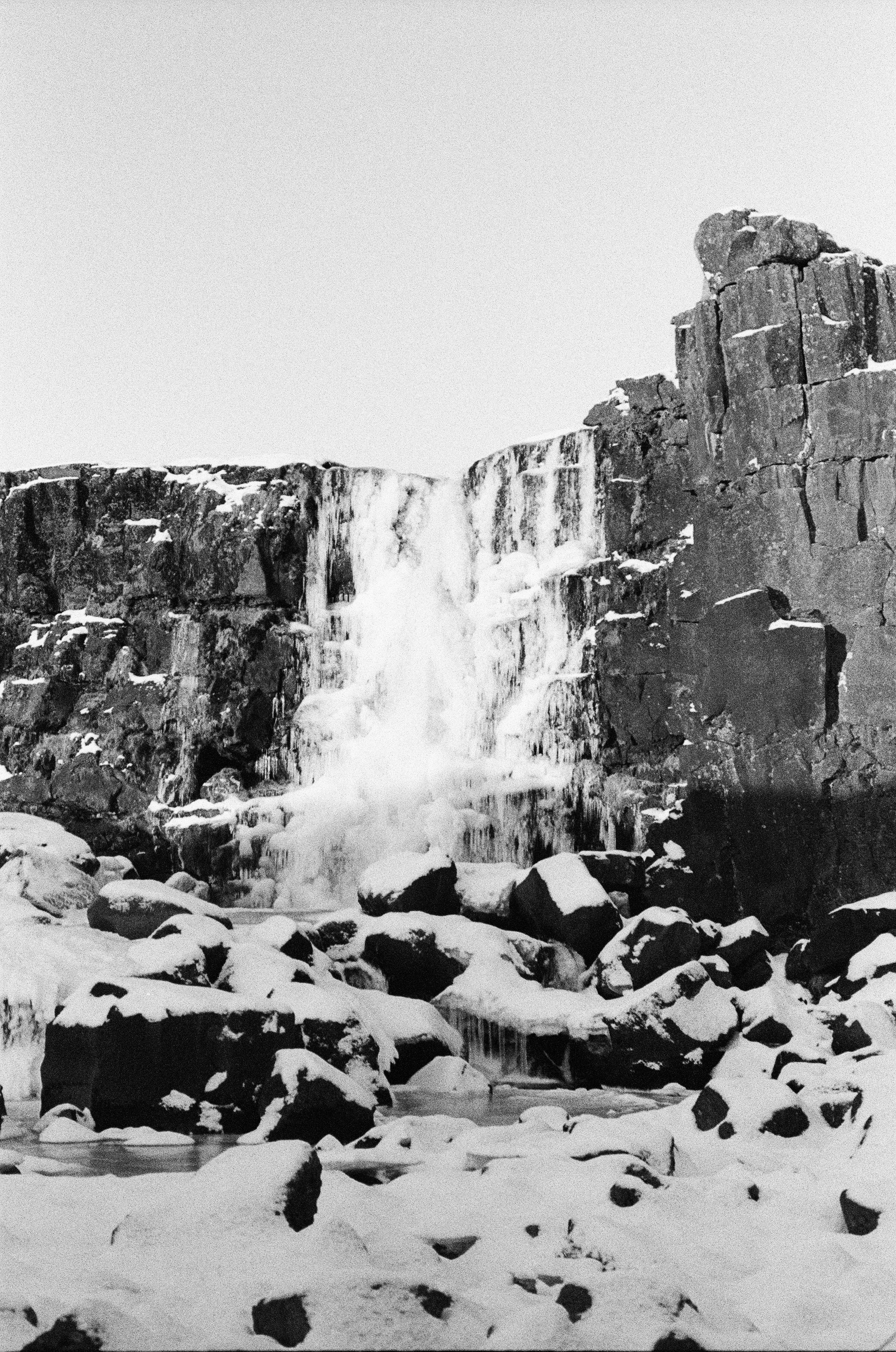Snowy Waterfall Surrounded By Rugged, Icy Cliffs. HD mobile wallpaper