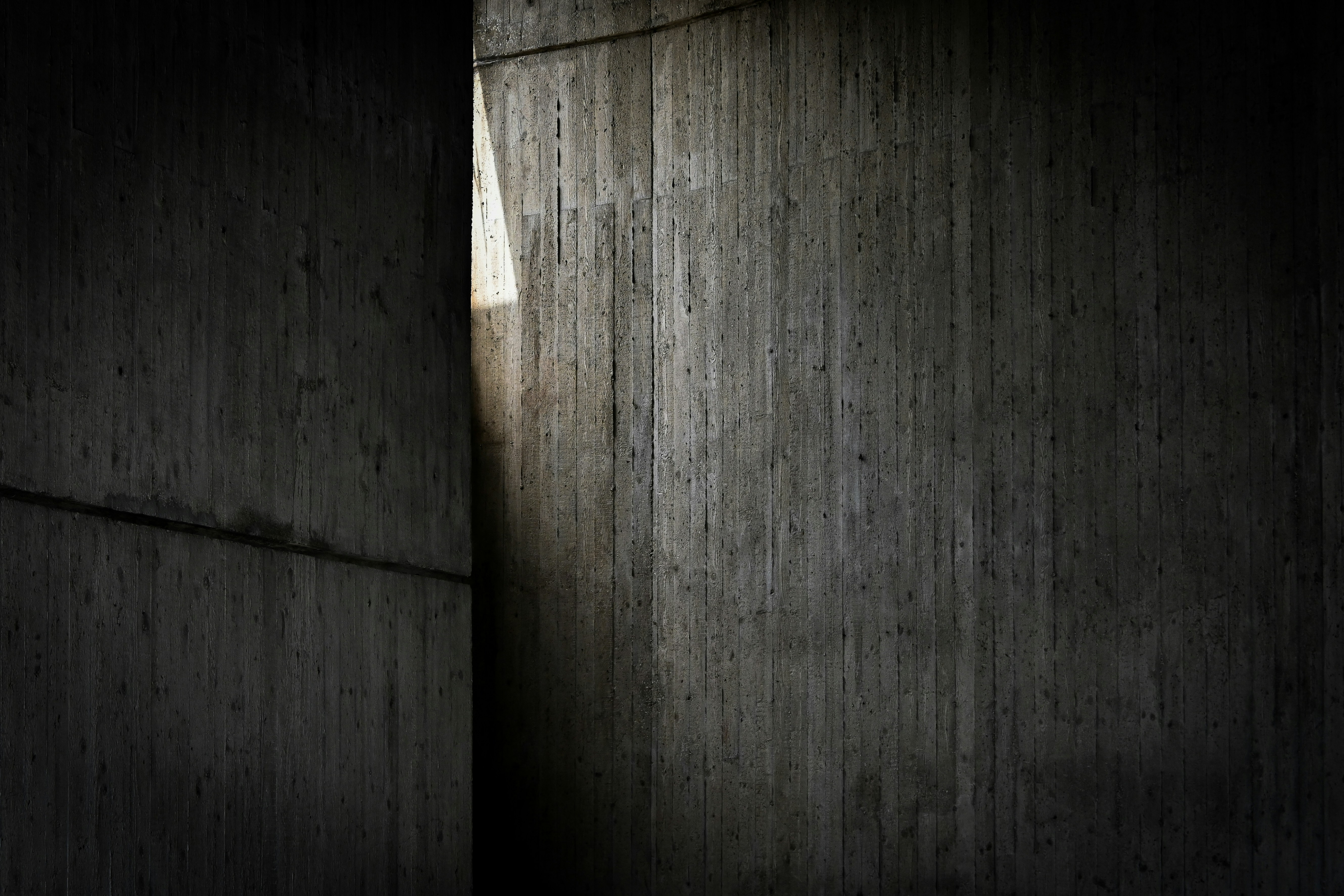 Light Streams Through A Vertical Gap In Dark Concrete. HD mobile wallpaper