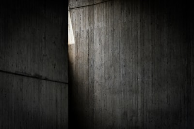 Light Streams Through A Vertical Gap In Dark Concrete.