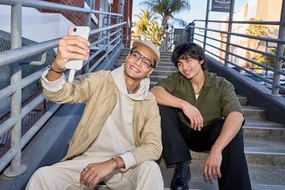 Two Young Men Taking A Selfie On Outdoor Stairs.