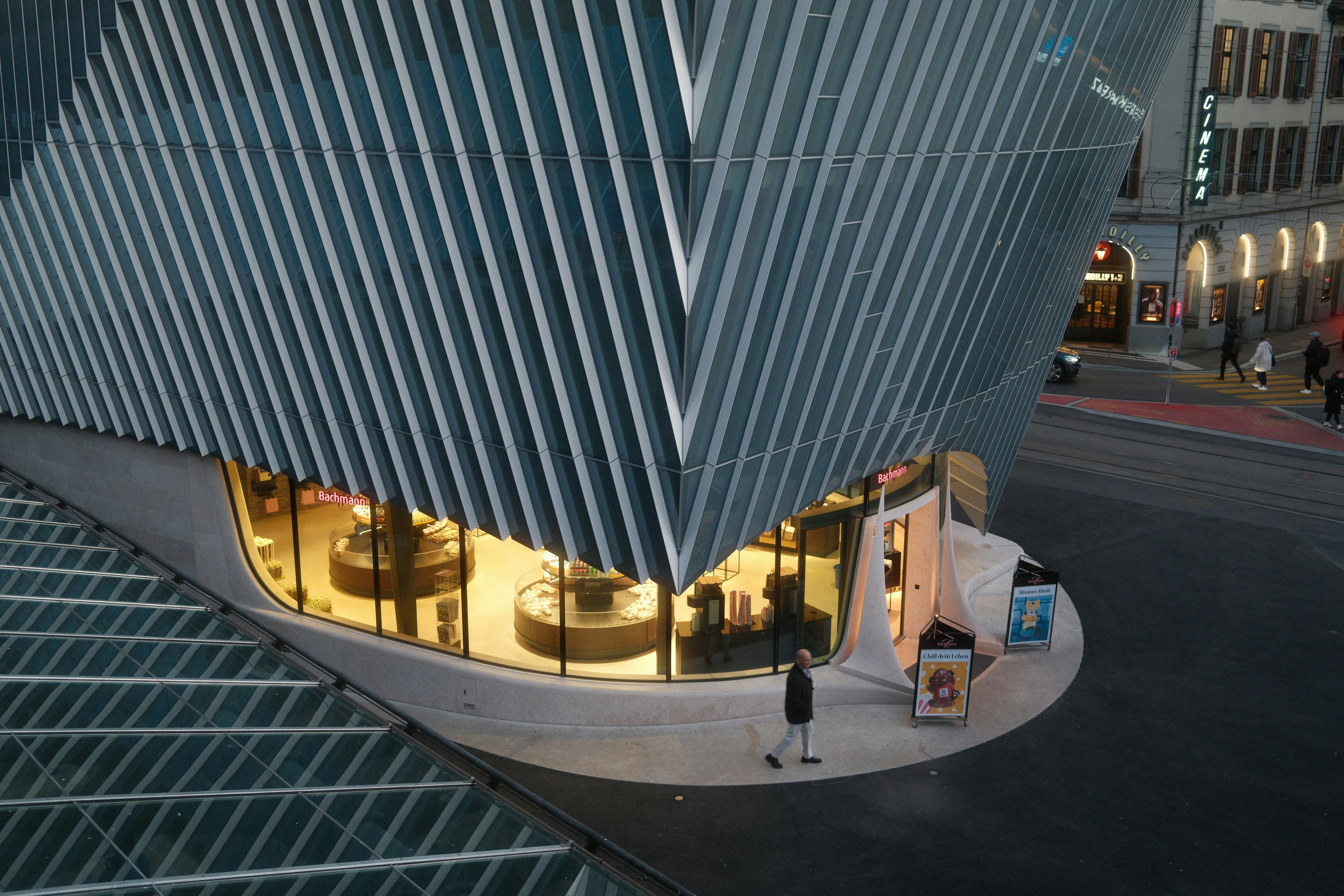 Modern Building With A Curved Facade And Illuminated Storefront. HD mobile wallpaper