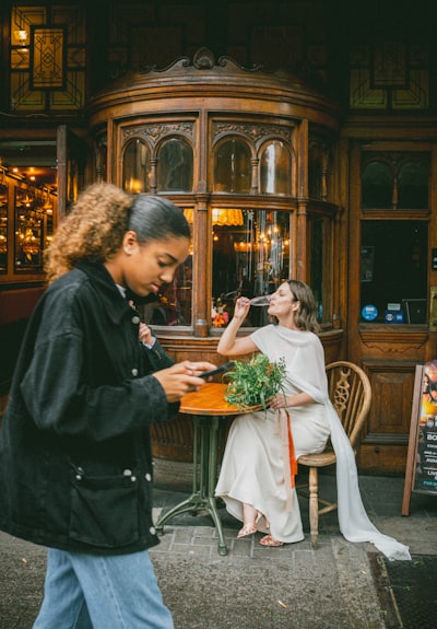 Bride Drinking Outside Pub As Woman Walks By