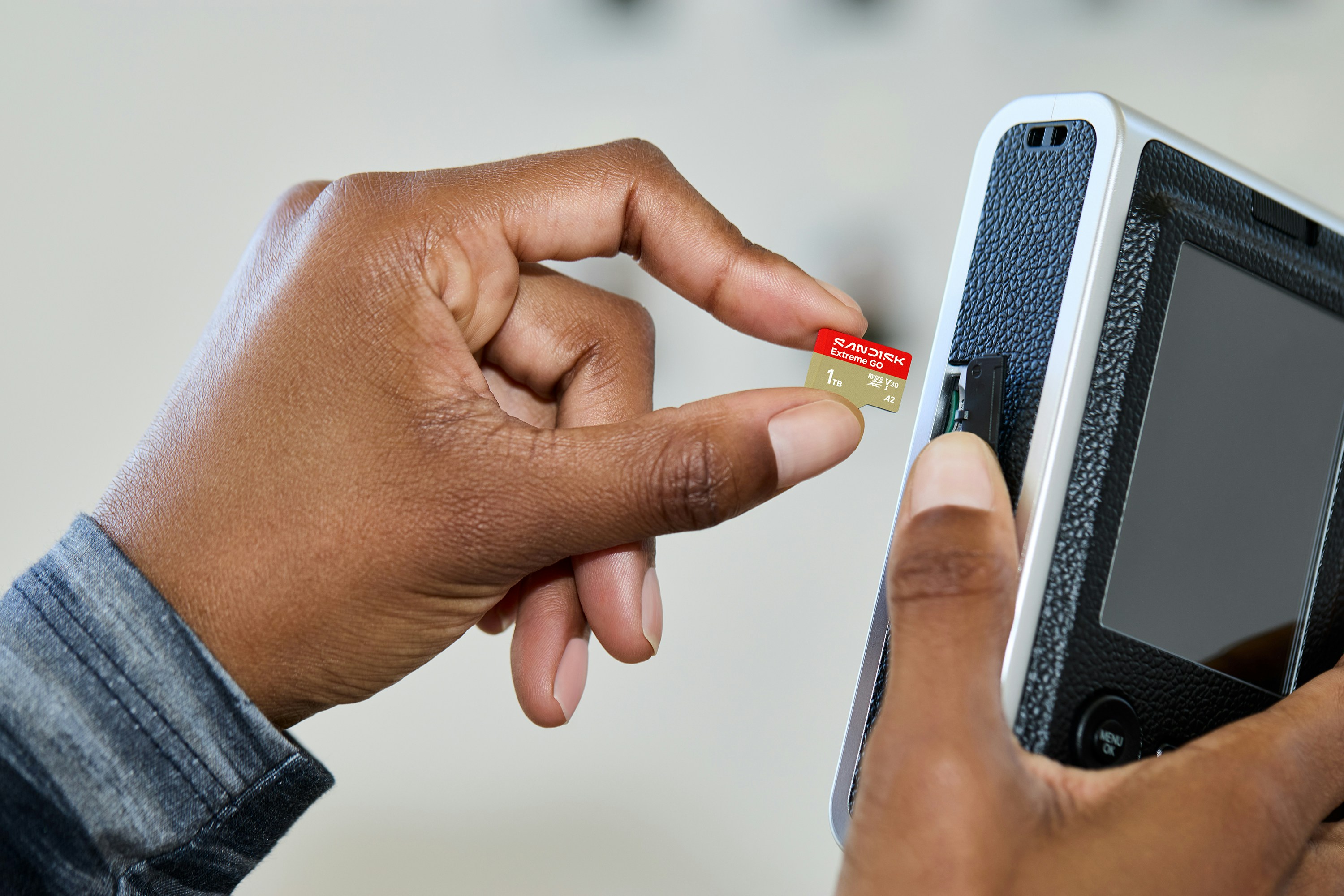 A Person Inserts A Memory Card Into A Digital Device. HD mobile wallpaper